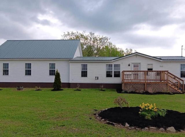 12 Parenteau Rd, Blaine, ME 04734 - back of property featuring metal roof, a yard, and a wooden deck