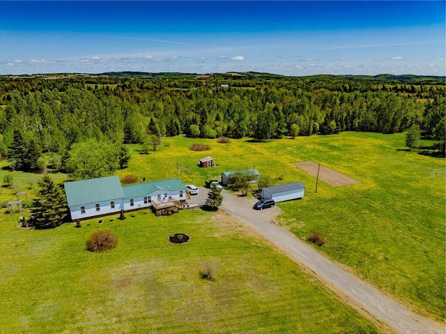 drone / aerial view featuring a wooded view