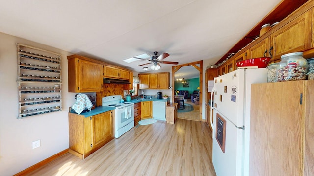 kitchen featuring brown cabinets, light wood-style flooring, ceiling fan, white appliances, and under cabinet range hood