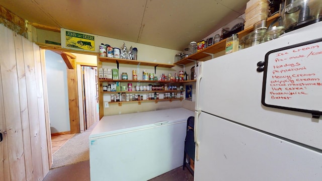 kitchen featuring open shelves, light countertops, and freestanding refrigerator