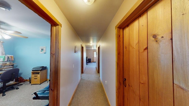 corridor with light carpet and baseboards