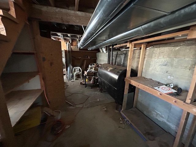 unfinished basement featuring heating fuel