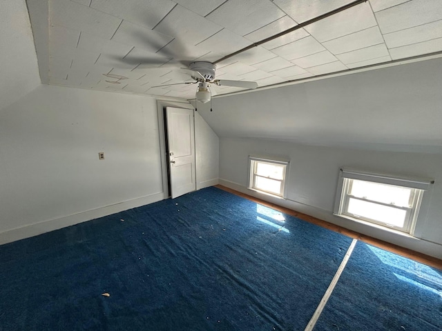 additional living space featuring carpet floors, lofted ceiling, and baseboards