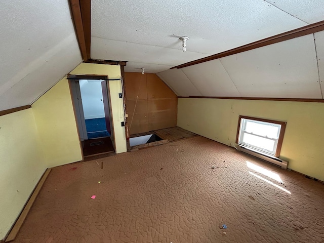 bonus room with lofted ceiling, baseboard heating, and a textured ceiling