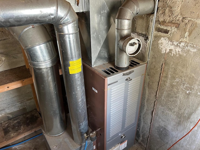 utility room featuring heating unit