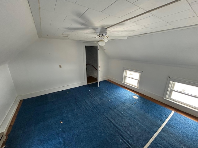 bonus room featuring vaulted ceiling, a ceiling fan, and baseboards