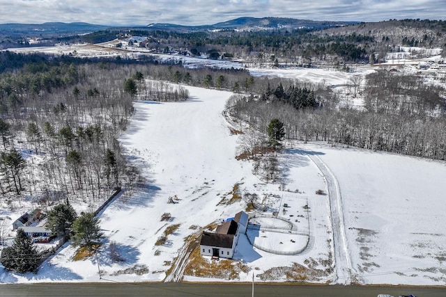 snowy aerial view with a mountain view