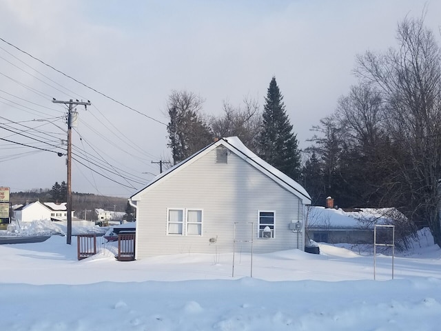 snow covered property featuring a deck