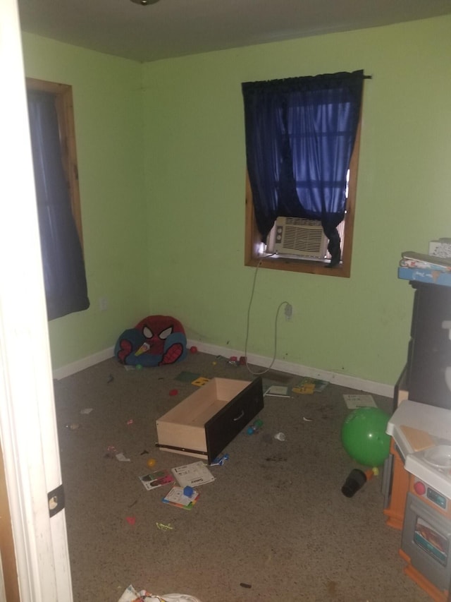 bedroom featuring cooling unit and baseboards