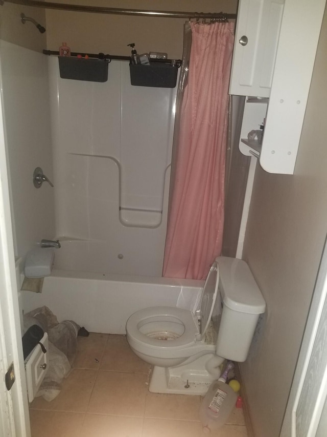 bathroom featuring tile patterned flooring, toilet, and shower / bathtub combination with curtain