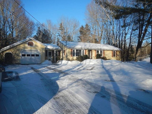 single story home with a garage and driveway