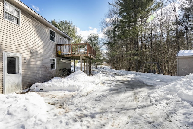 snowy yard with a deck