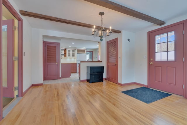 entryway featuring a notable chandelier, light wood finished floors, beam ceiling, and baseboards