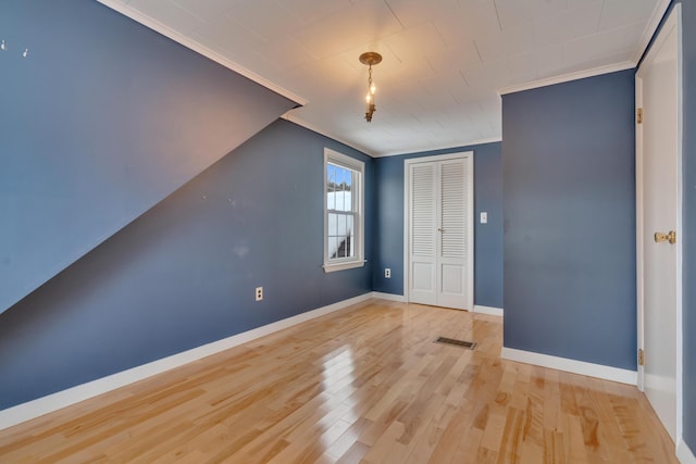 bonus room featuring visible vents, baseboards, and wood finished floors