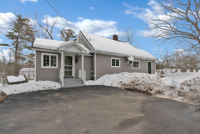 view of front of property with fence and a chimney