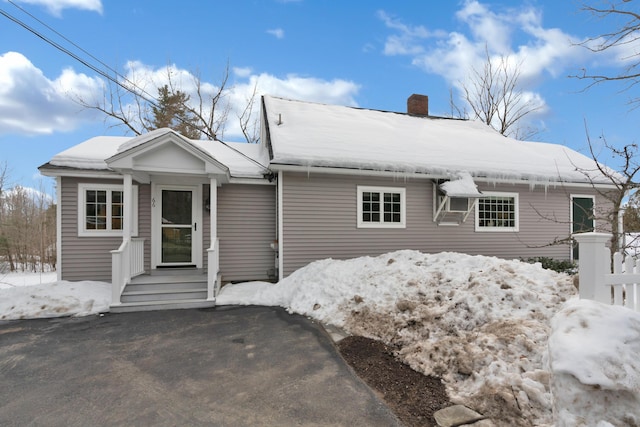 single story home featuring a chimney