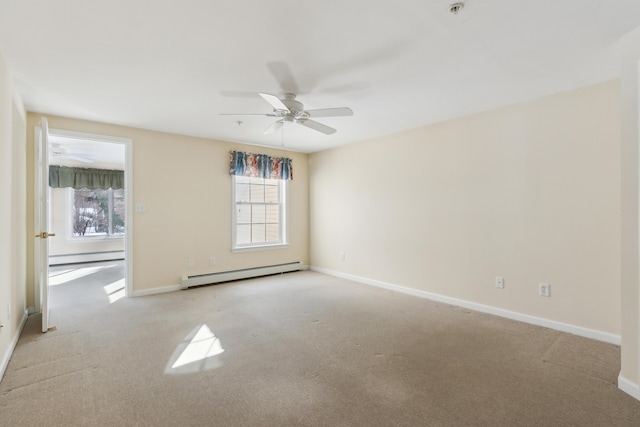 carpeted spare room with a baseboard heating unit, baseboards, and baseboard heating