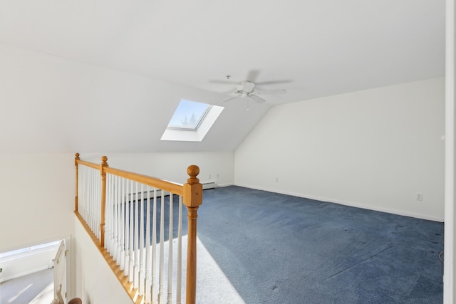 additional living space featuring carpet, baseboard heating, lofted ceiling with skylight, ceiling fan, and baseboards