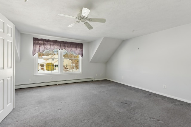 bonus room featuring baseboards, ceiling fan, carpet, a textured ceiling, and a baseboard heating unit