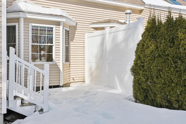 property entrance with a shingled roof