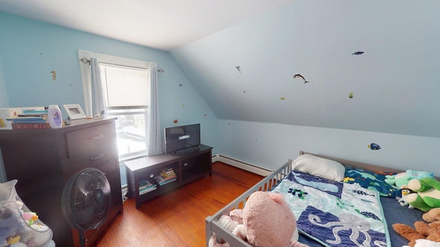 bedroom with vaulted ceiling, baseboard heating, and wood-type flooring