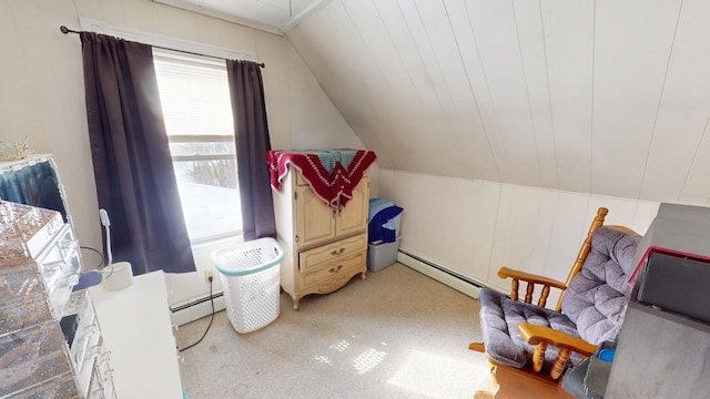 sitting room with a baseboard heating unit, lofted ceiling, and light colored carpet