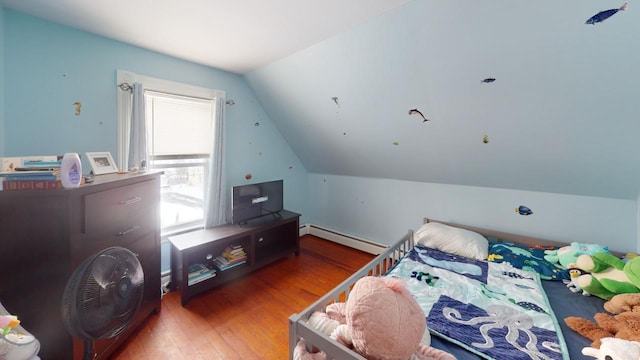 bedroom with wood-type flooring, a baseboard heating unit, and vaulted ceiling