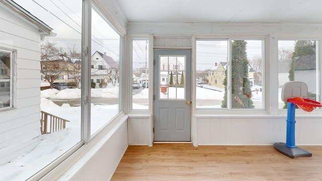 sunroom featuring a healthy amount of sunlight and a residential view