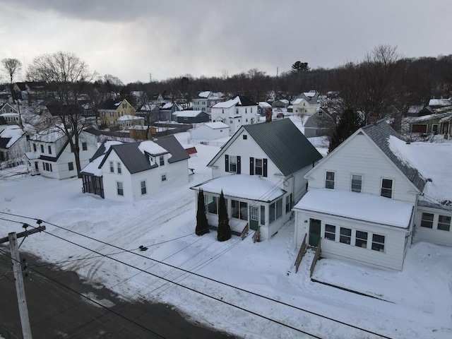 snowy aerial view featuring a residential view