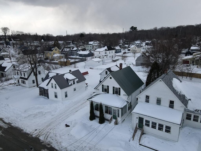 snowy aerial view featuring a residential view