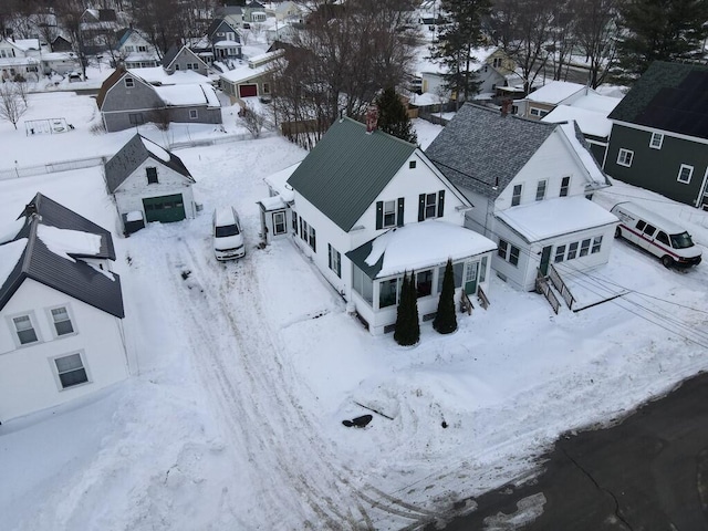 snowy aerial view featuring a residential view