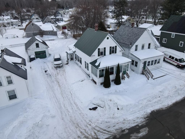 snowy aerial view featuring a residential view