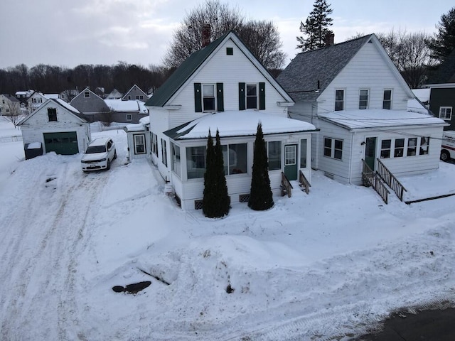 view of front of house with a garage and a sunroom