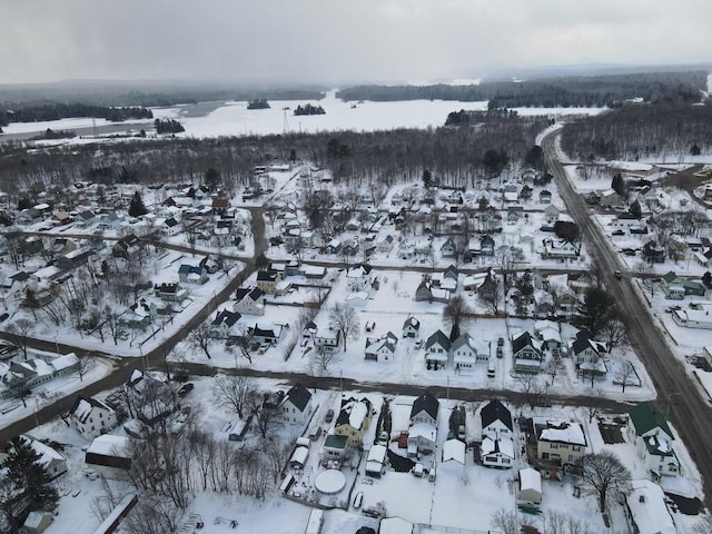 snowy aerial view with a residential view