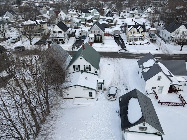 snowy aerial view with a residential view