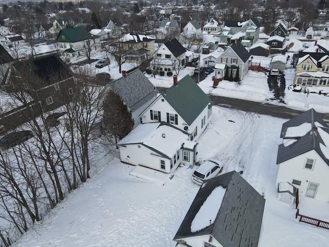 snowy aerial view with a residential view