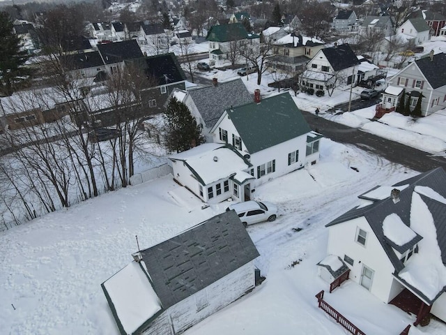 snowy aerial view with a residential view