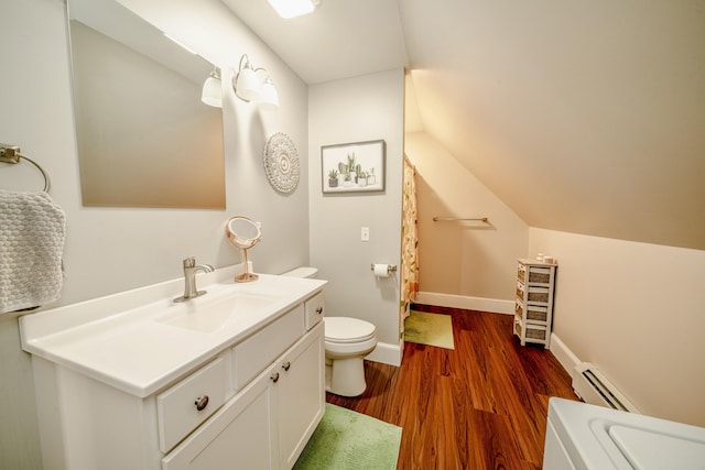 full bathroom with toilet, a baseboard heating unit, wood finished floors, baseboards, and vaulted ceiling