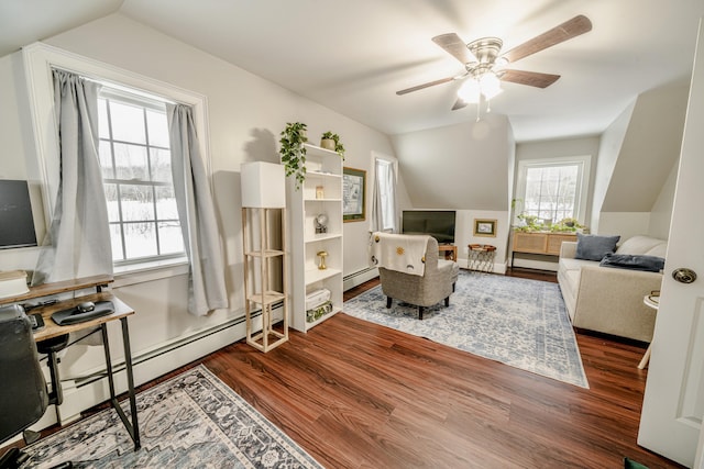 living area featuring lofted ceiling, ceiling fan, a baseboard heating unit, and wood finished floors