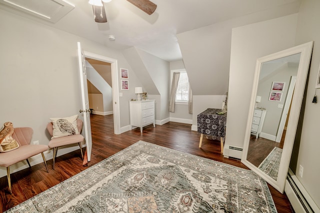 interior space with baseboard heating, wood finished floors, and baseboards