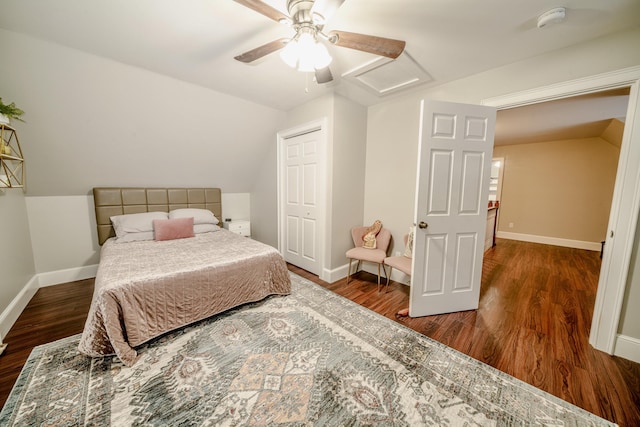 bedroom featuring lofted ceiling, attic access, ceiling fan, wood finished floors, and baseboards