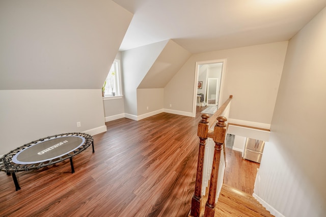 bonus room with vaulted ceiling, baseboards, and wood finished floors