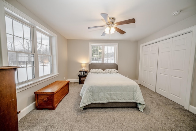 bedroom with a closet, carpet flooring, and baseboards