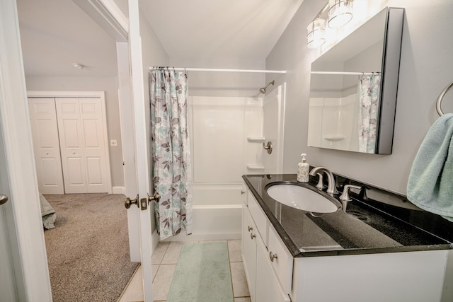 bathroom featuring tile patterned flooring, shower / bath combo, and vanity