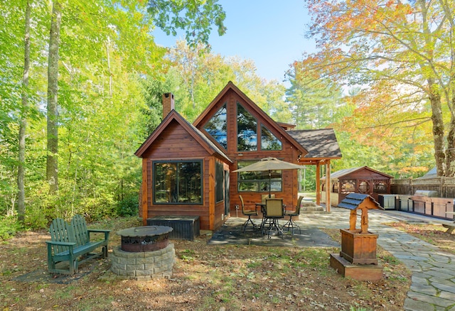 view of patio featuring a hot tub, an outdoor fire pit, and a gazebo