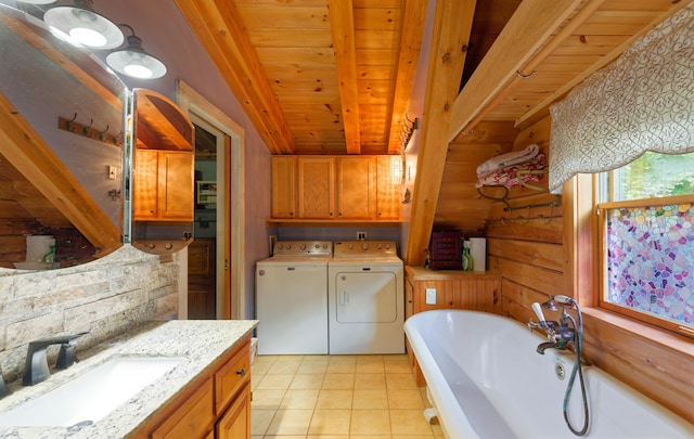 bathroom featuring vaulted ceiling with beams, wooden ceiling, a freestanding tub, independent washer and dryer, and tile patterned floors