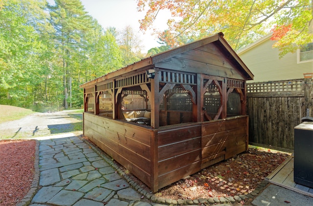 view of outbuilding featuring an outdoor structure and fence