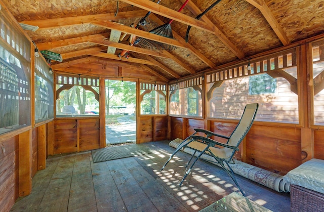 sunroom / solarium featuring vaulted ceiling