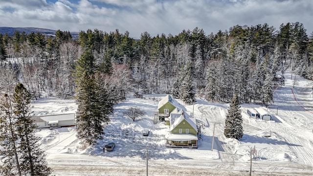 snowy aerial view with a forest view