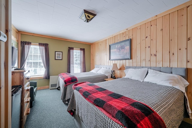 carpeted bedroom with wood walls